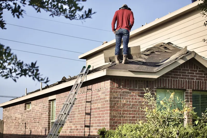 Professional roofer working on a residential roof in Pine Lake